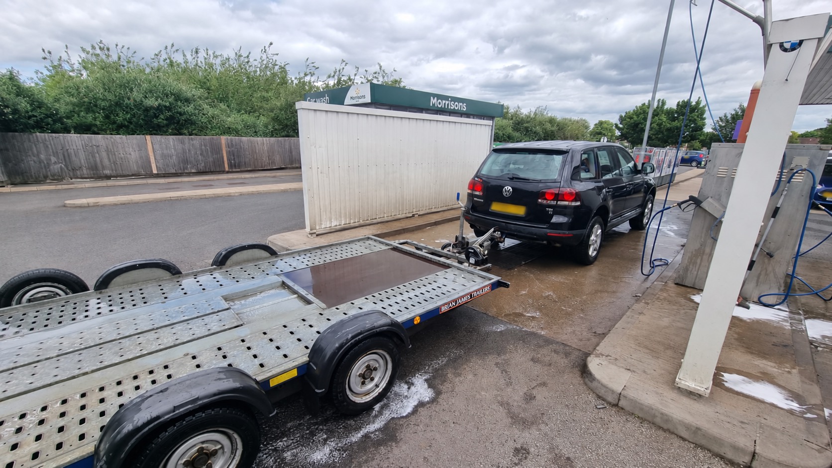 Empty twin-axle Brian James car transporter trailer